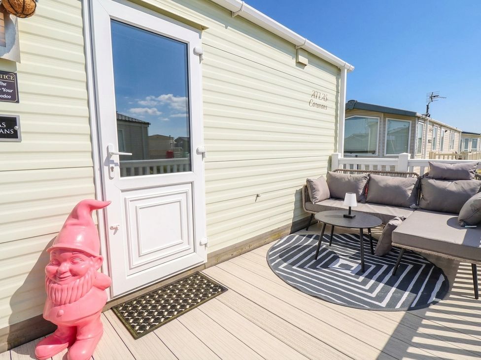 An outdoor patio with a sofa and table at Atlas in Ingoldmells