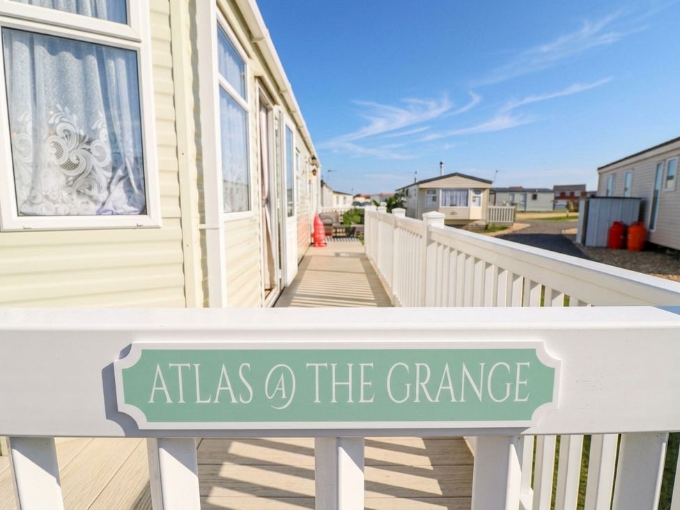 An outdoor view of a caravan with a sign at Atlas at The Grange in Ingoldmells