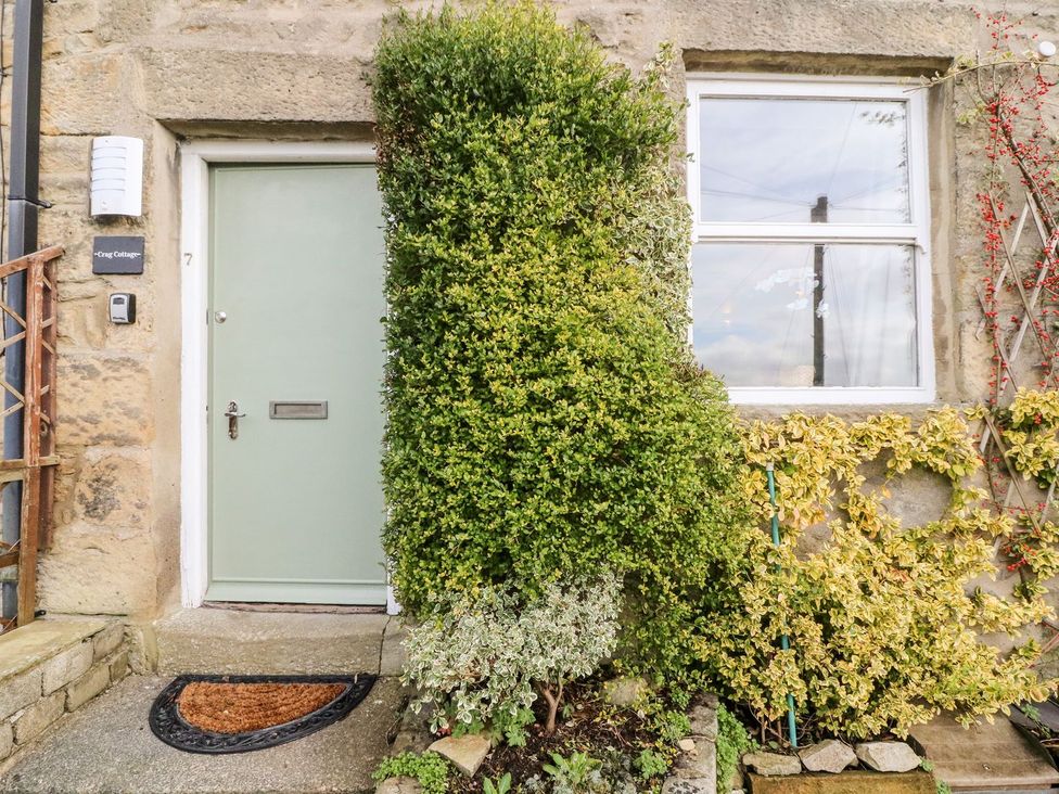 A front door and window with plants at Crag Cottage Settle