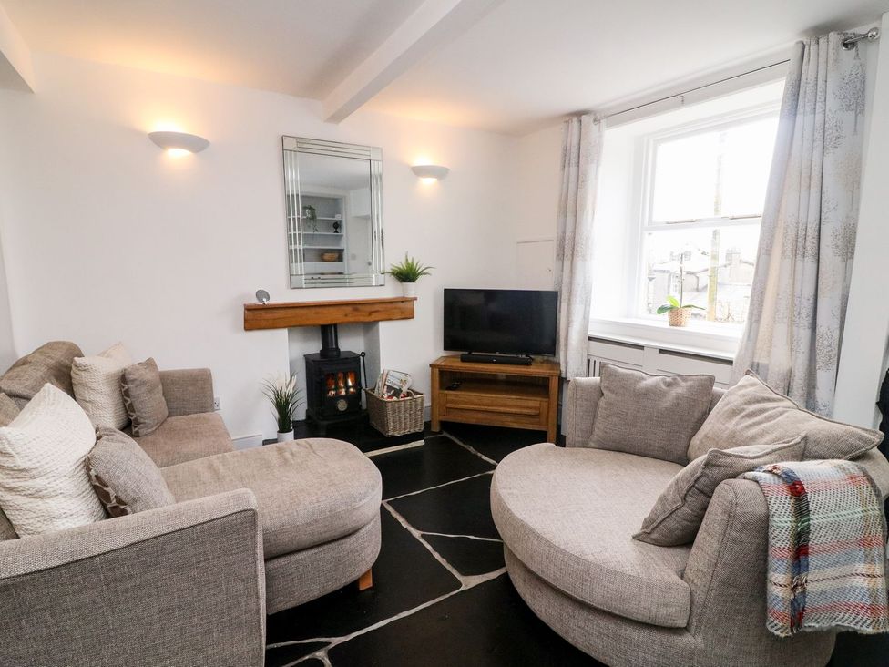 A living room with a sofa and television at Crag Cottage in Settle