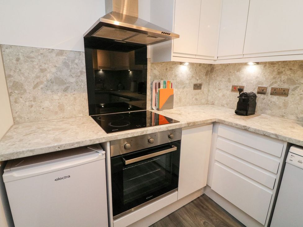 A kitchen with an oven and fridge at Crag Cottage Settle