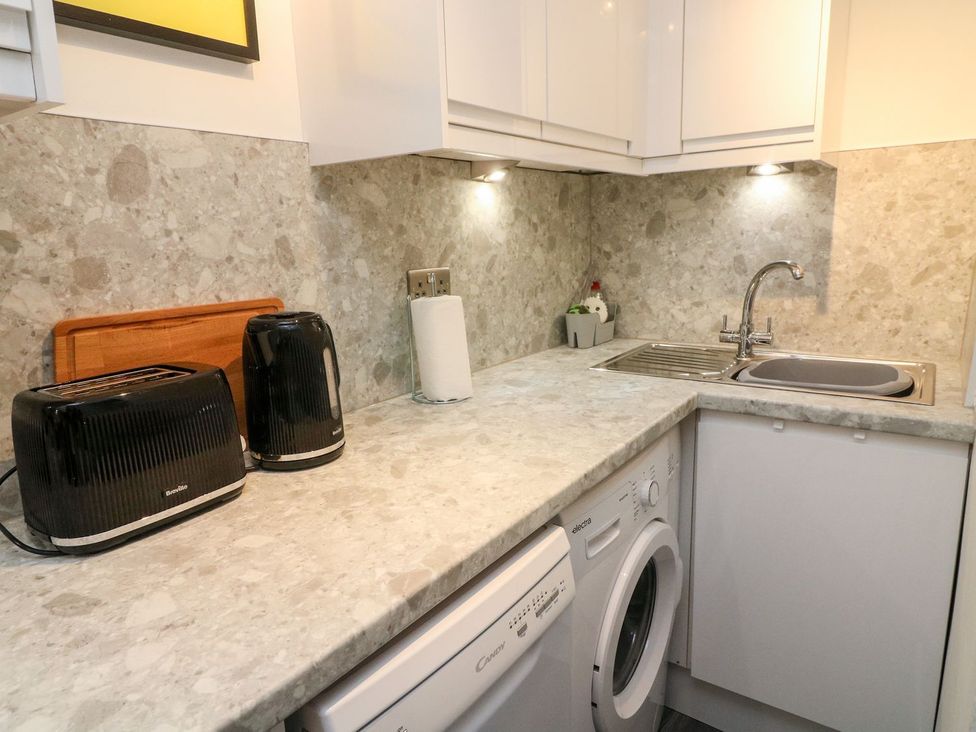 A kitchen with appliances and a sink at Crag Cottage in Settle