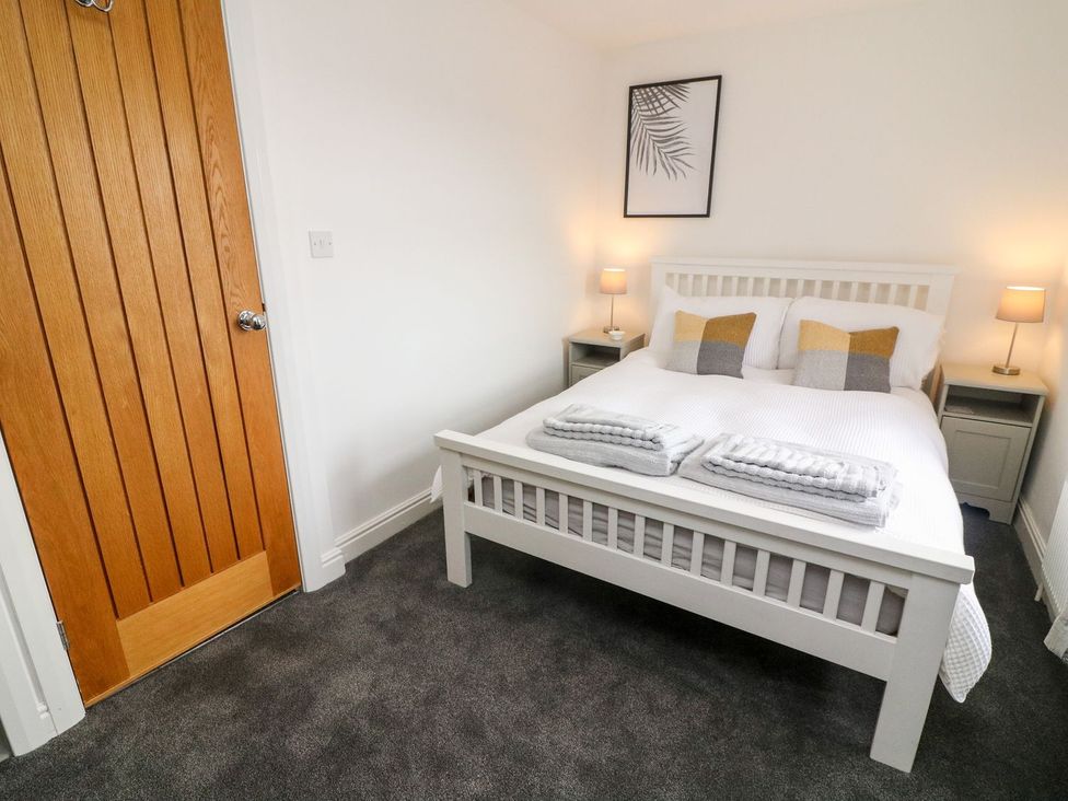 A bedroom with a bed and bedside tables at Crag Cottage in Settle