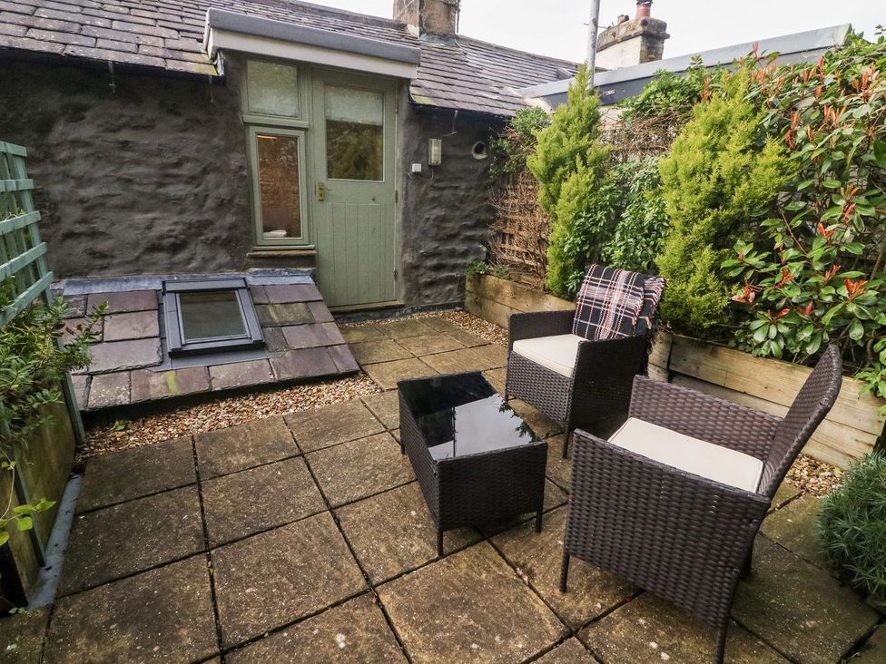 A garden with outdoor furniture and plants at Crag Cottage Settle