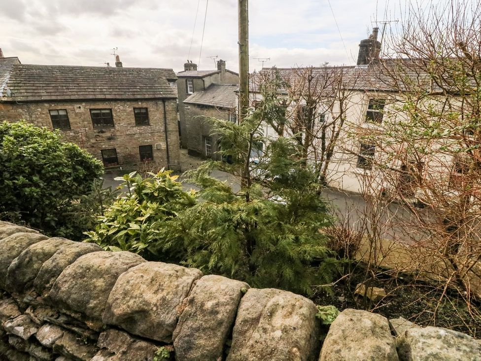 A view of buildings and trees from an outdoor location at Crag Cottage Settle