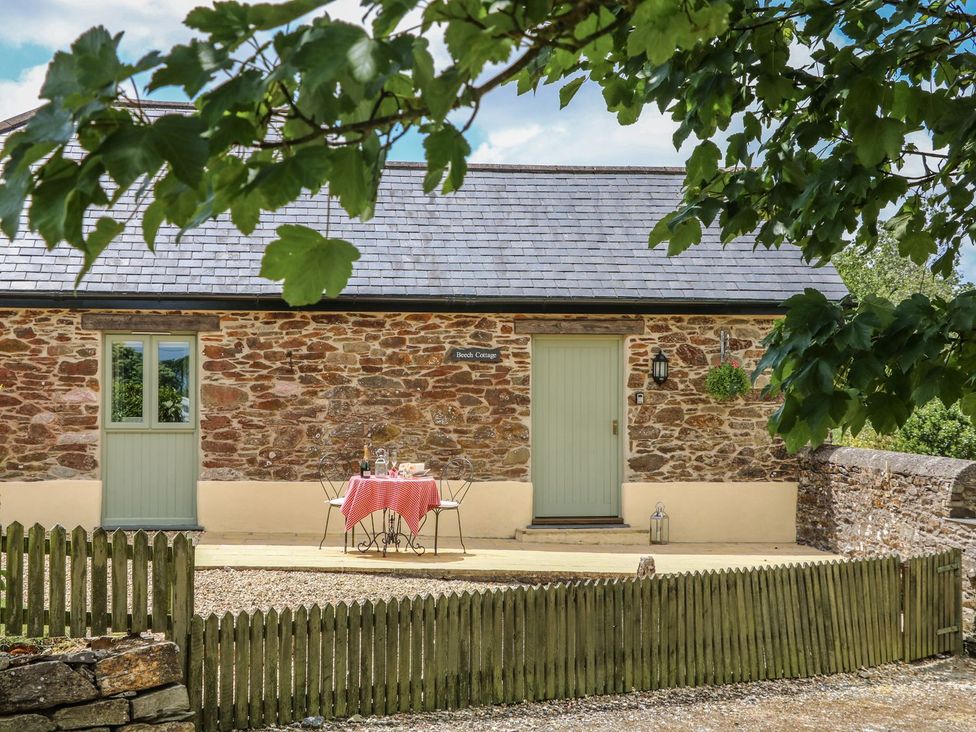 An outdoor area with a table and chairs at Beech Cottage in Truro