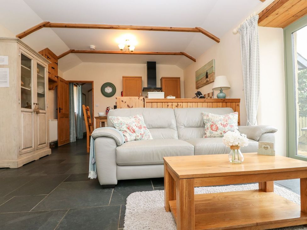 A living room with a sofa and coffee table at Beech Cottage in Truro
