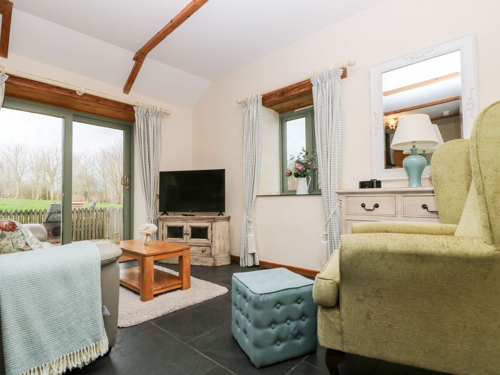 A living room with a sofa and coffee table at Beech Cottage in Truro