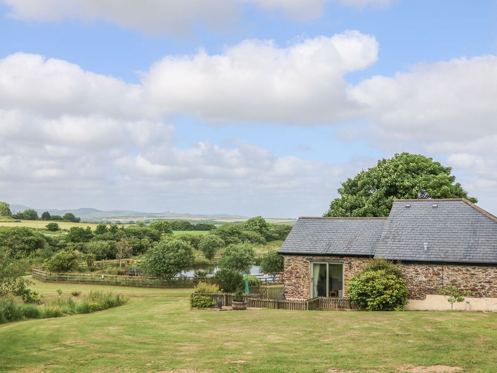 A house surrounded by trees and a pond at Beech Cottage in Truro