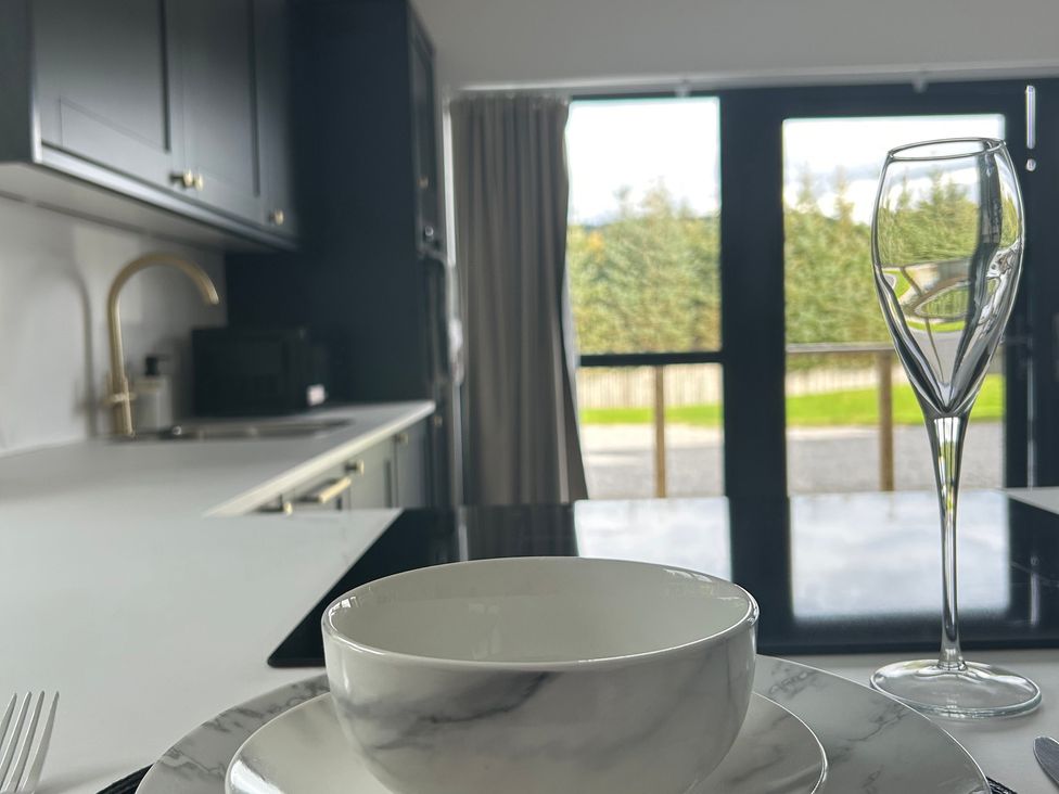 A kitchen with a bowl and glass on a table at Broomfield Hideaway near Inverness