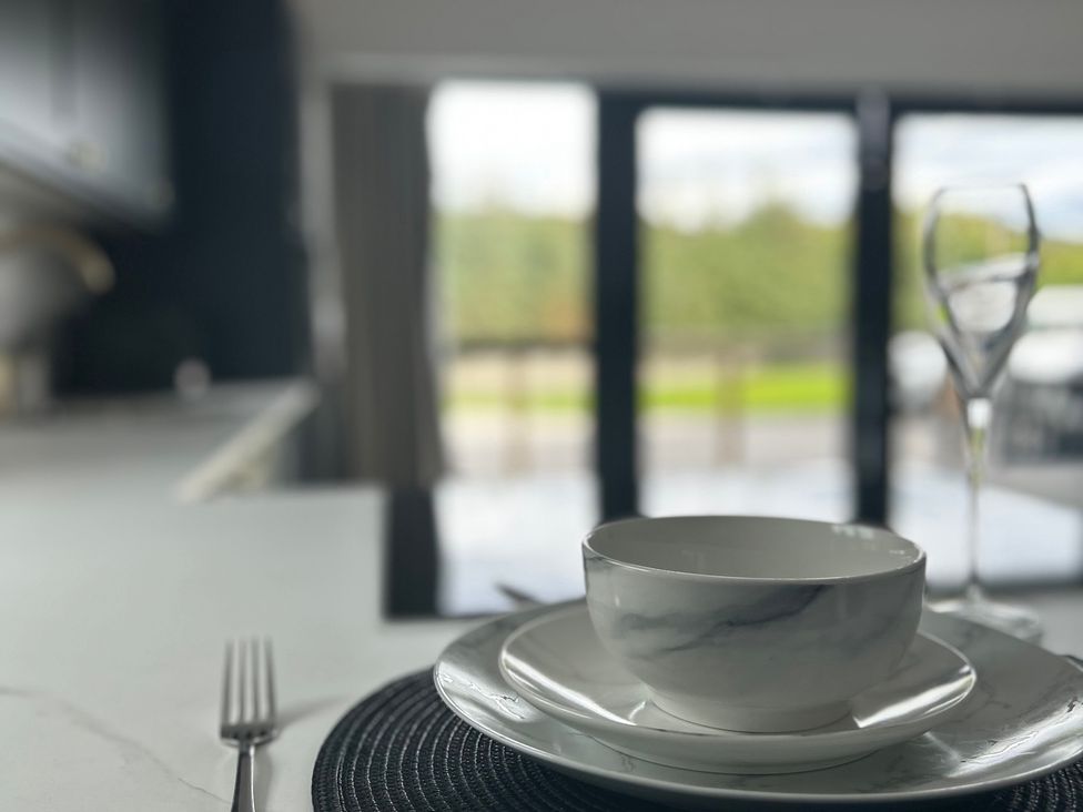 A kitchen table setting with a bowl and glass at Broomfield Hideaway near Inverness