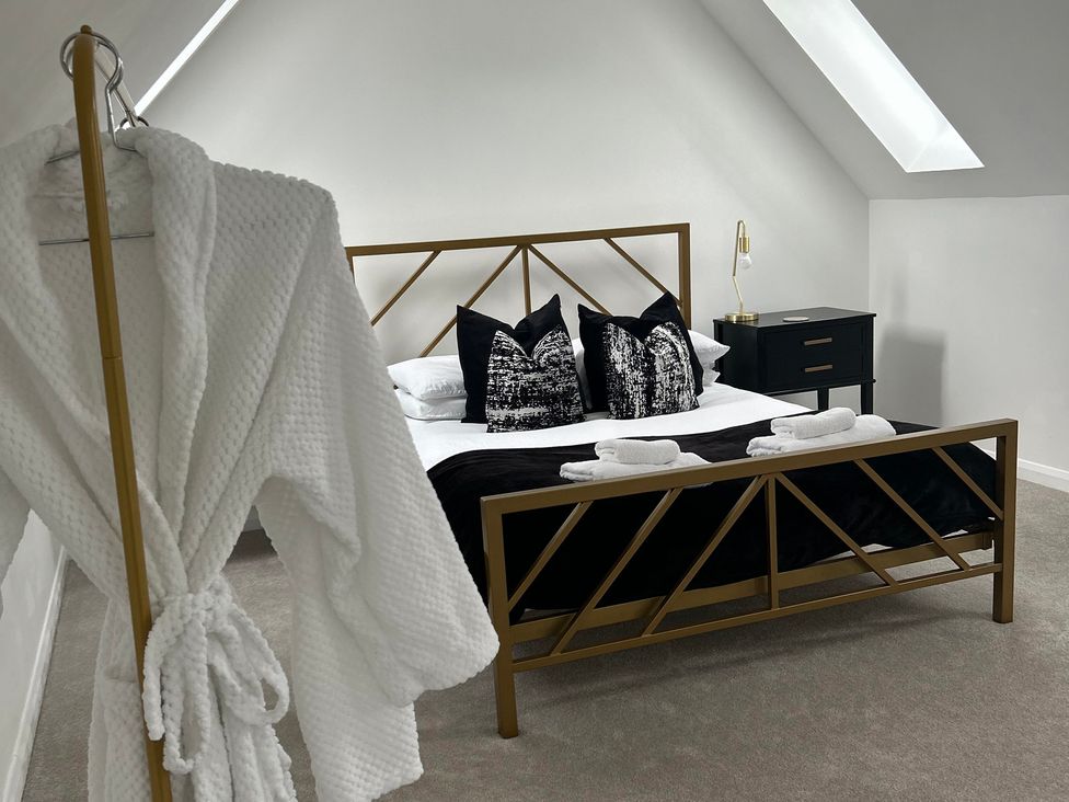 A bedroom with a bed and nightstand at Broomfield Hideaway near Inverness