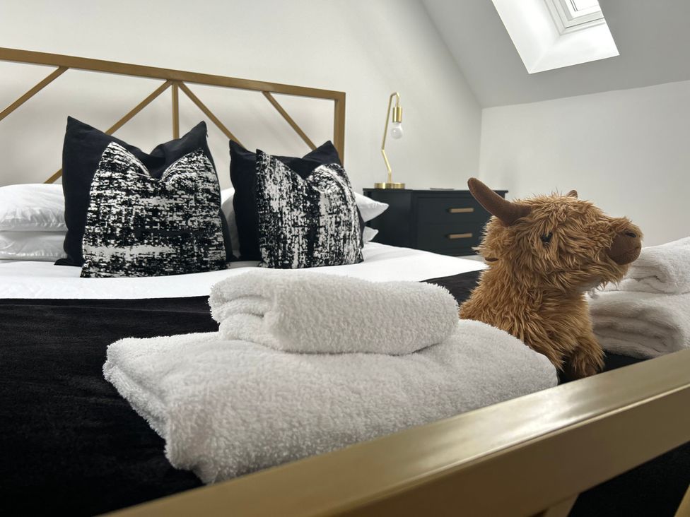 A bedroom with a bed and pillows at Broomfield Hideaway near Inverness