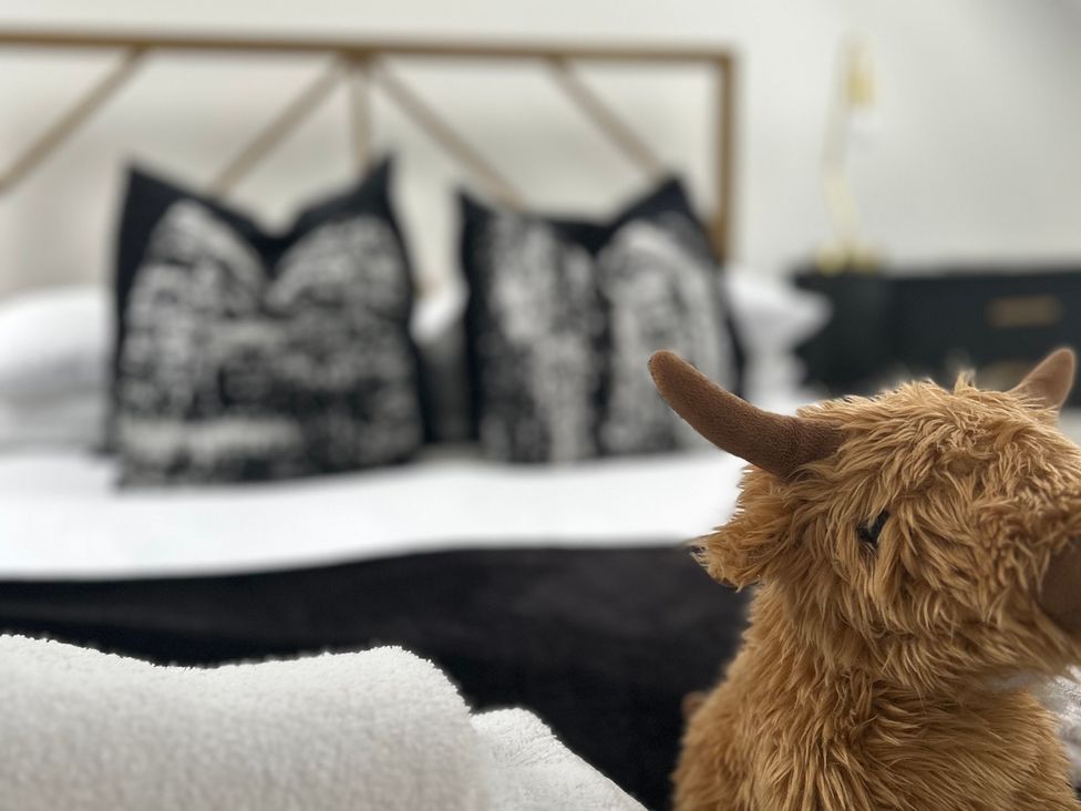 A bedroom with a bed and pillows at Broomfield Hideaway near Inverness