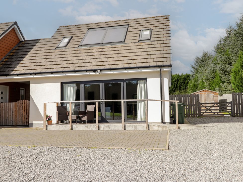 A house with a patio and gravel area at Broomfield Hideaway near Inverness