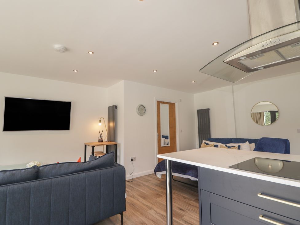 A living room with a television and sofa at Broomfield Hideaway near Inverness