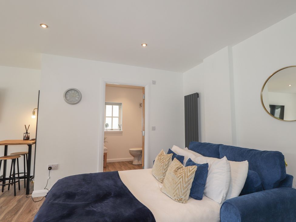 A bedroom with a bed and visible door to bathroom at Broomfield Hideaway near Inverness