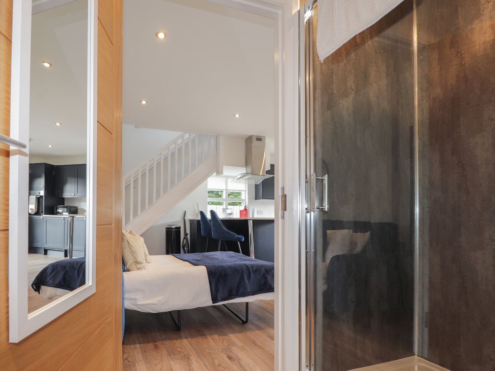 A bedroom with a bed and a shower at Broomfield Hideaway near Inverness