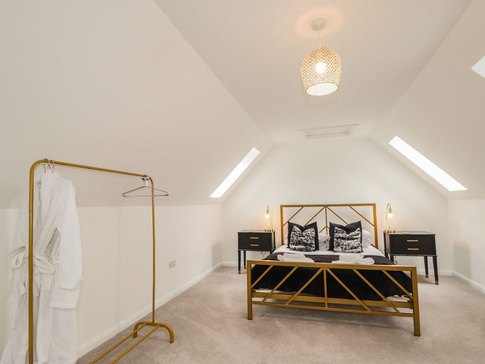 A bedroom with a bed and nightstands at Broomfield Hideaway near Inverness