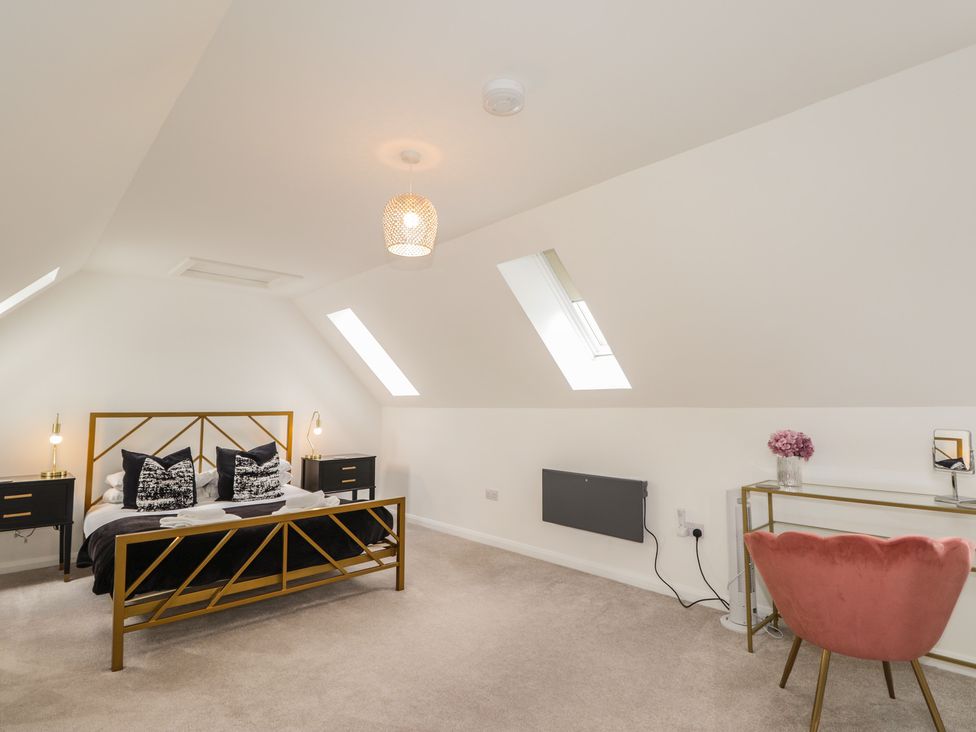 A bedroom with a bed and desk at Broomfield Hideaway near Inverness