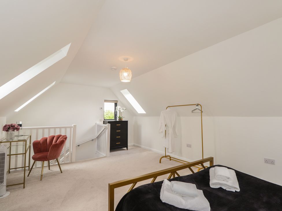 A bedroom with a bed and dressing table at Broomfield Hideaway near Inverness
