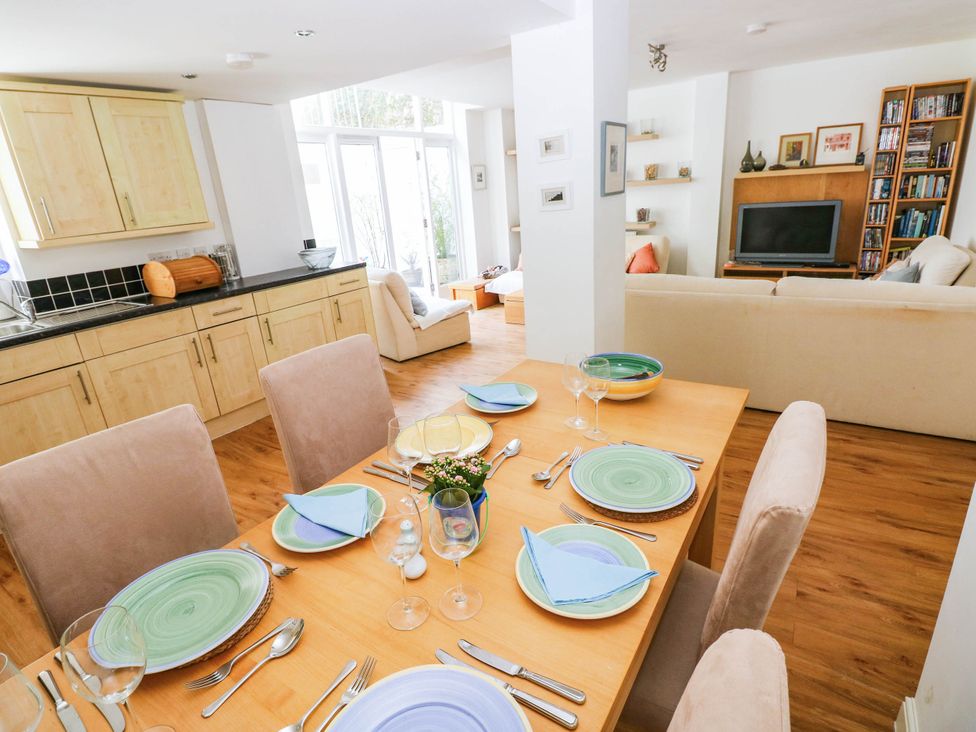A dining area with a table and chairs at the Basement Apartment in Tenby