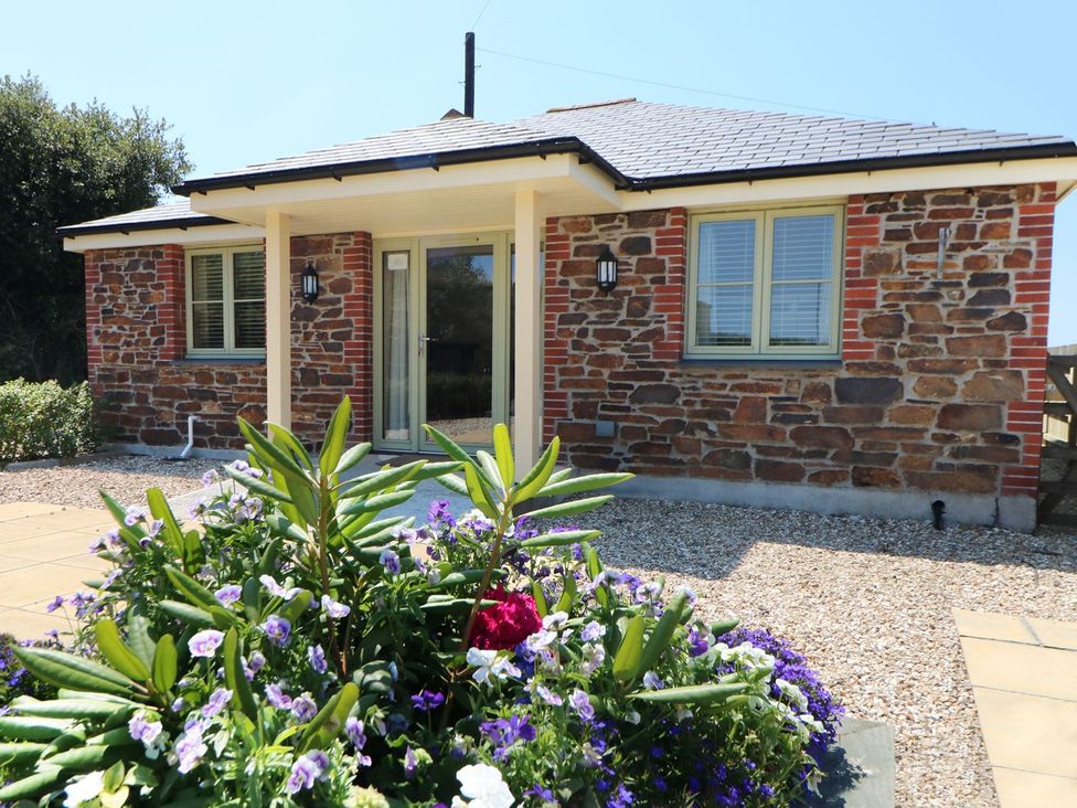 A house with a flower bed and pathway at Elm Cottage in Truro