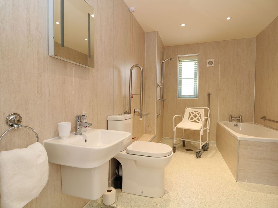 A bathroom with a sink toilet shower and bath at Elm Cottage in Truro