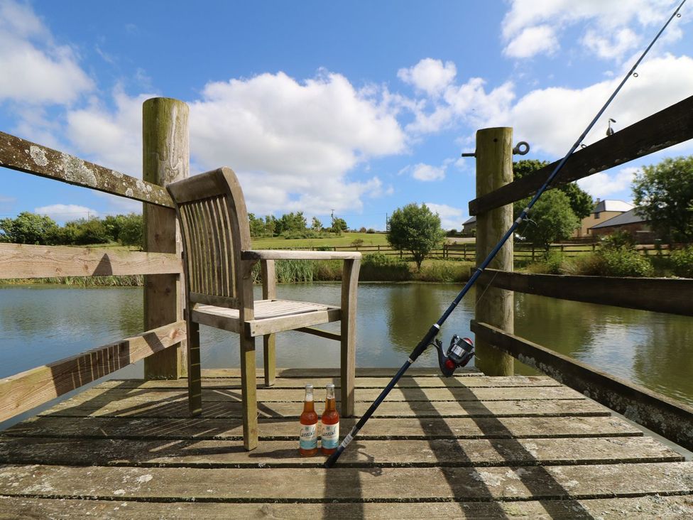 A fishing spot with a chair and fishing gear at Elm Cottage in Truro