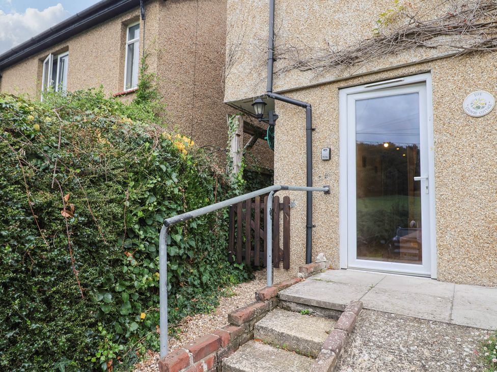 An outdoor entryway with steps and a door at Coombe Cottage Apartment Axmouth