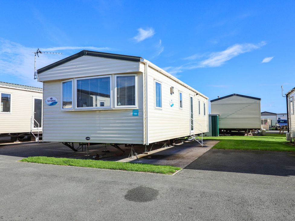 A mobile home with stairs and windows at Beach Fields 45 Kinmel Bay