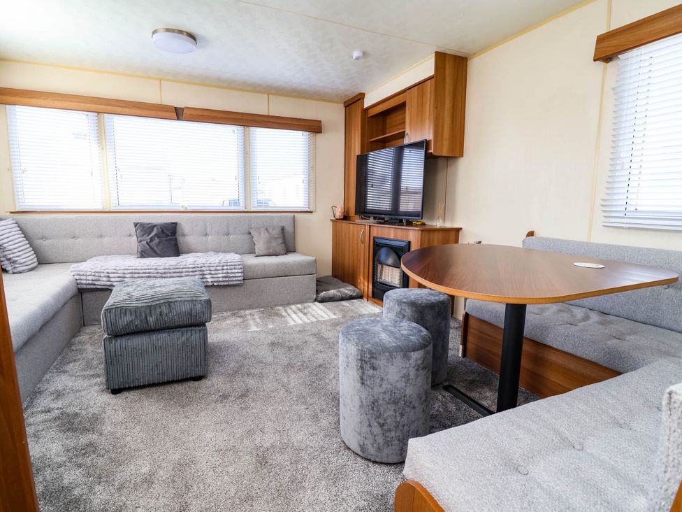 A living room with a television and sofa at Beach Fields 45 in Kinmel Bay