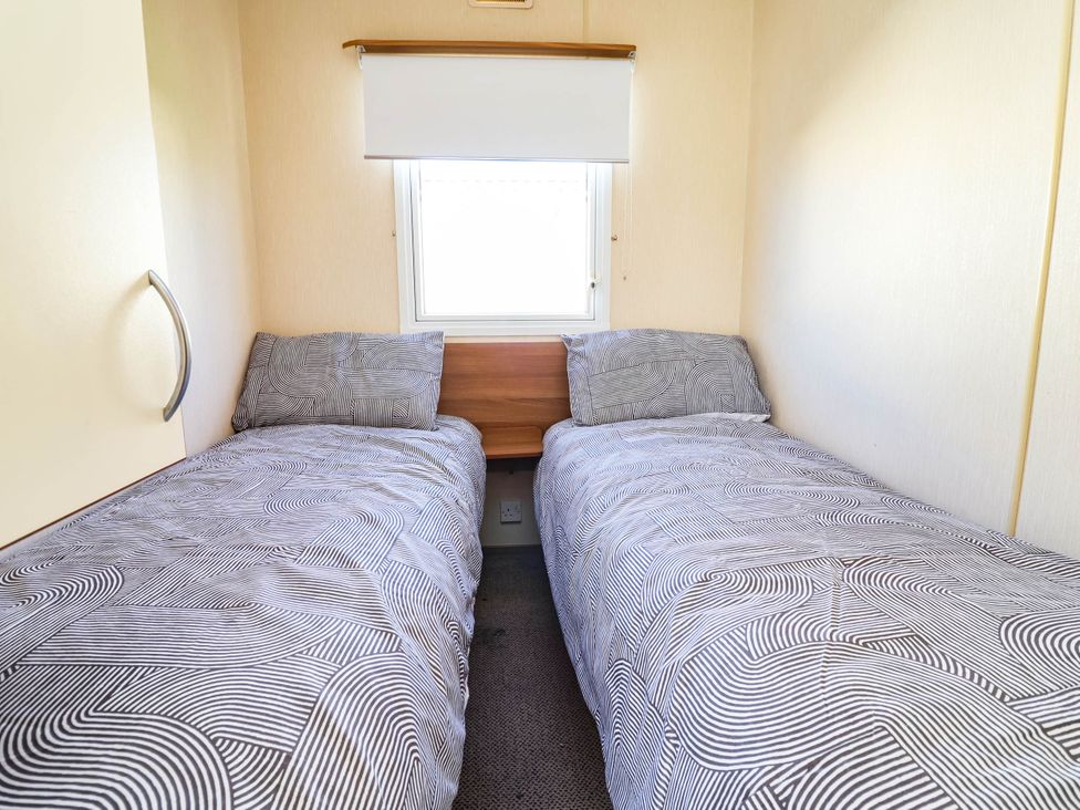 A bedroom with two beds and a window at Beach Fields 45, Kinmel Bay