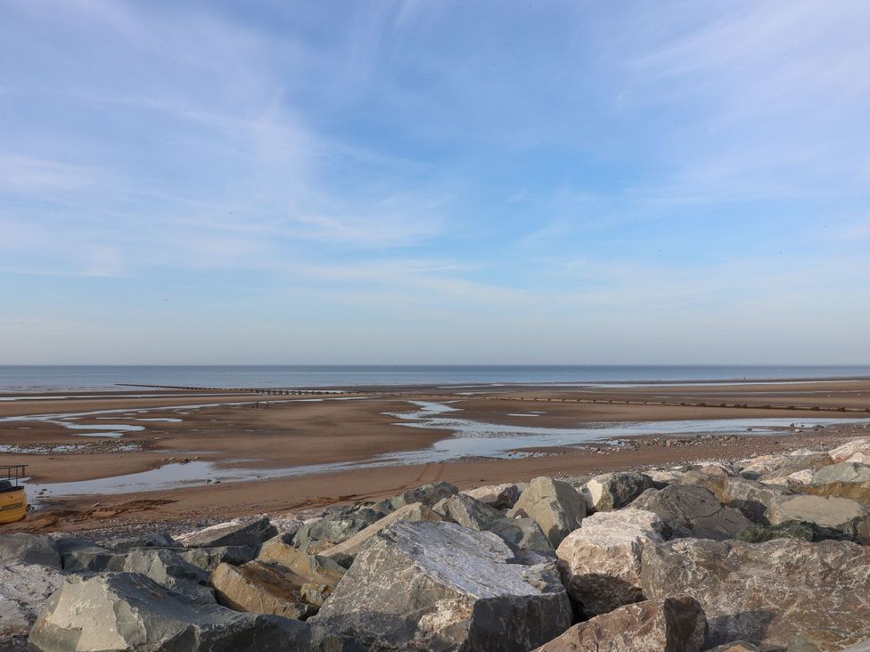 A coastal view with rocks and a pier at Beach Fields 45 in Kinmel Bay