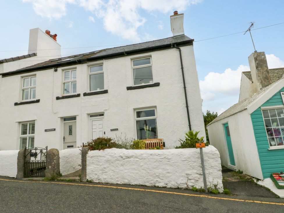 An outdoor view of a house with a garden at Mor Awelon in Moelfre