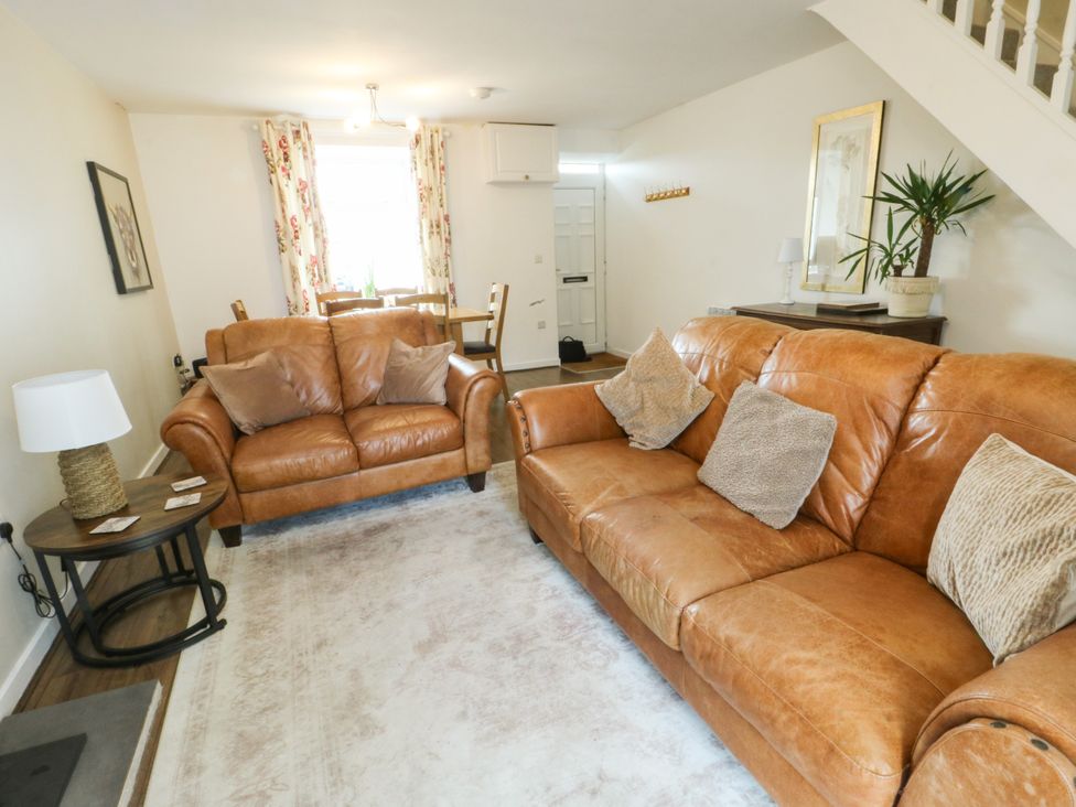 A living room with sofas and a coffee table at Mor Awelon, Moelfre