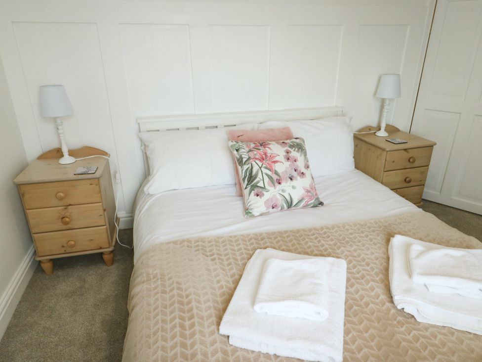 A bedroom with a bed and bedside tables at Mor Awelon in Moelfre