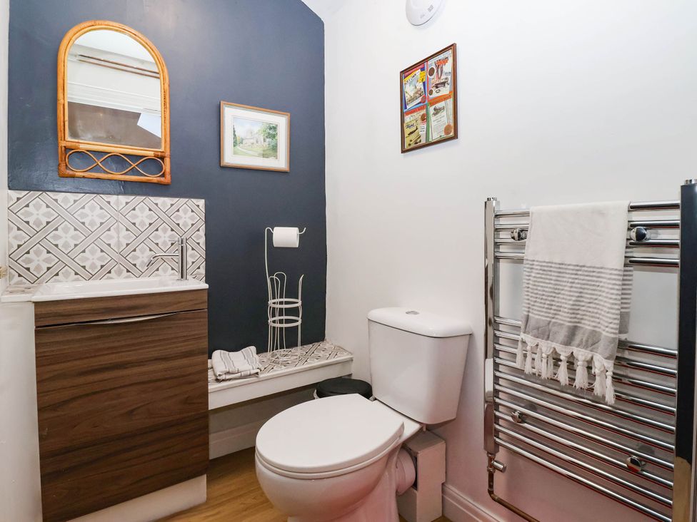 A bathroom with a sink and toilet at Winksey Cottage in Harrogate