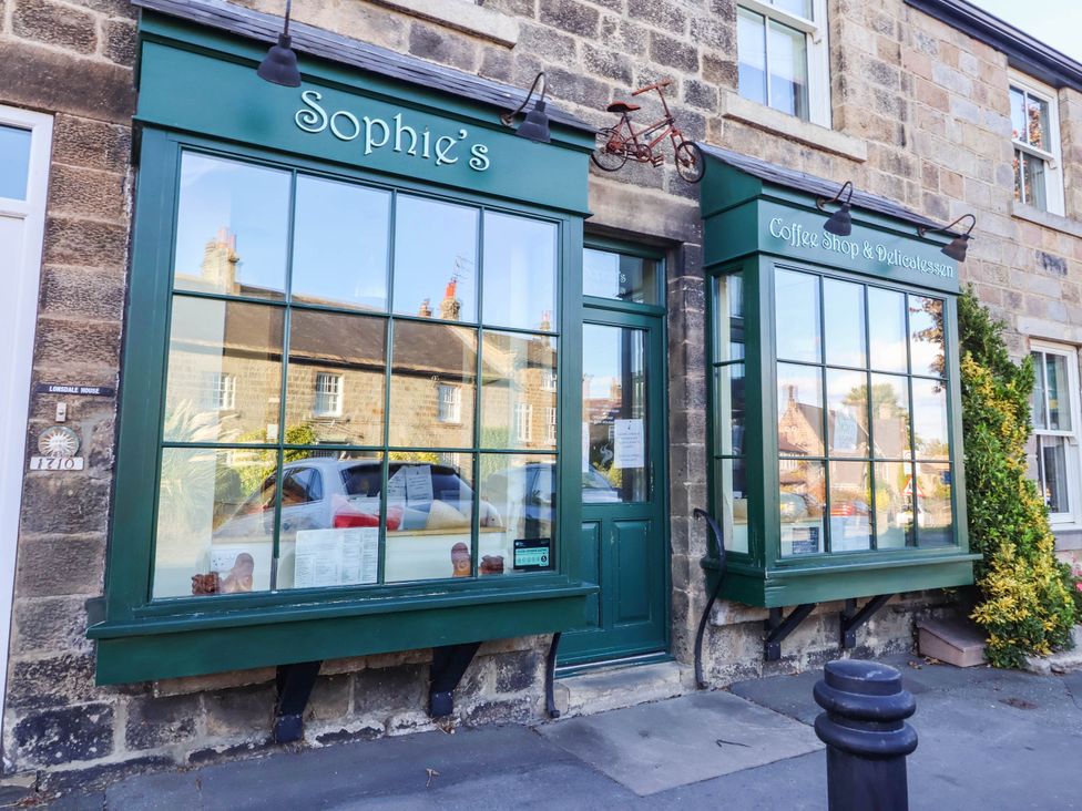 A coffee shop exterior with large windows at Winksey Cottage in Harrogate