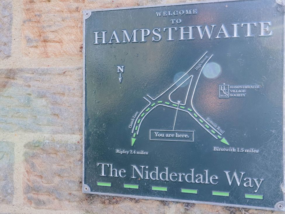A welcome sign with a map and directions in Hampsthwaite