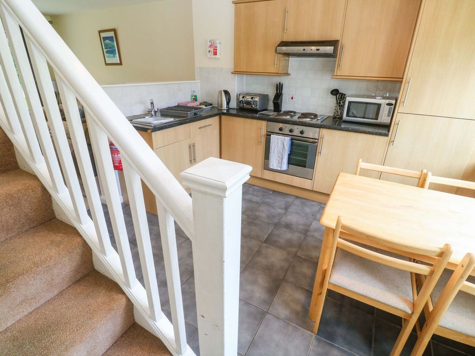 A kitchen with a table and chairs at 87 Atlantic Reach in Newquay