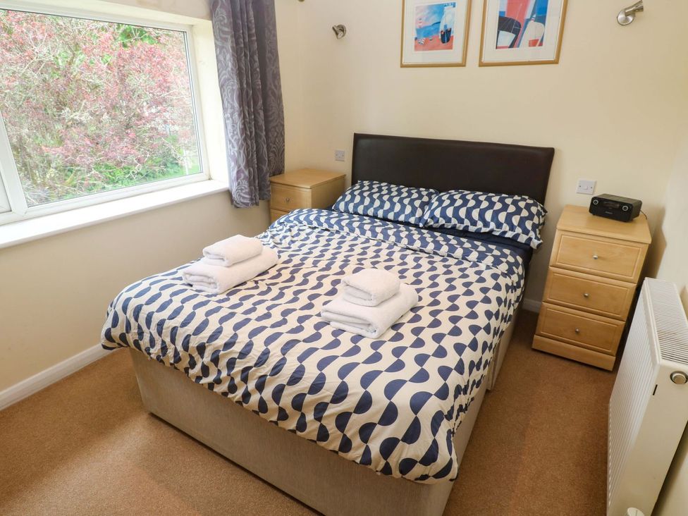 A bedroom with a bed and window at 87 Atlantic Reach Newquay