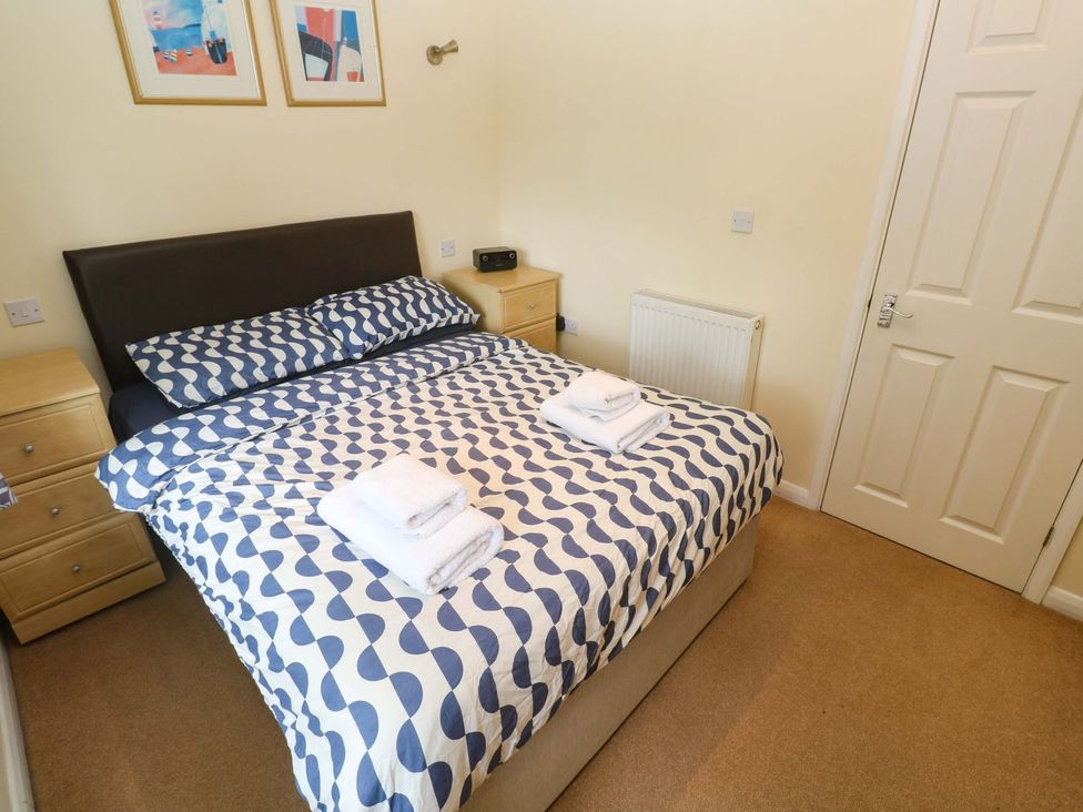 A bedroom with a bed and bedside table at 87 Atlantic Reach Newquay