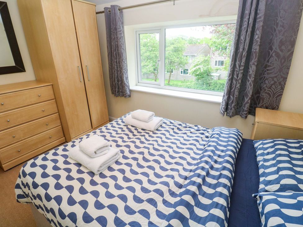 A bedroom with a bed, wardrobe, and dresser at 87 Atlantic Reach Newquay
