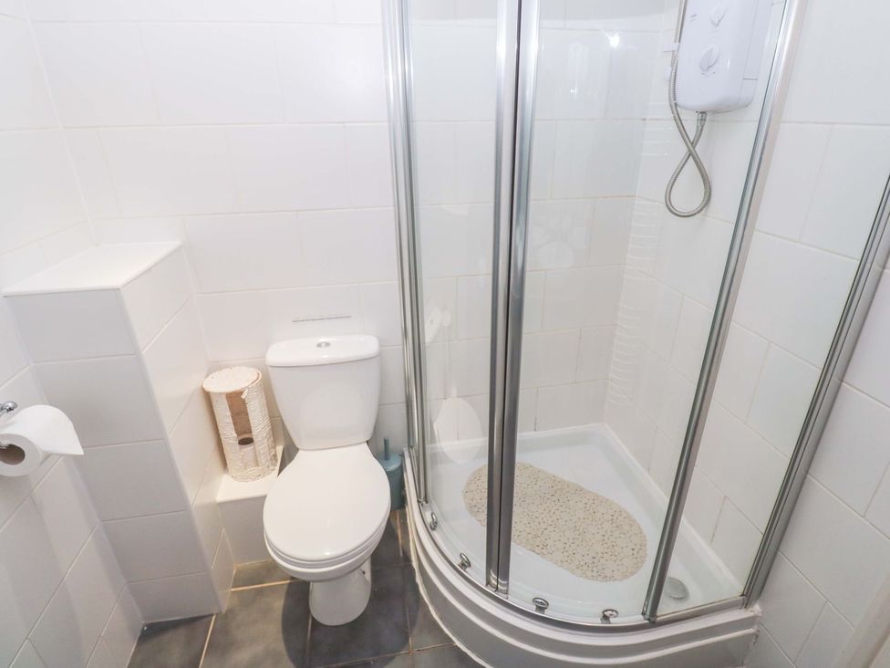 A bathroom with a shower and toilet at 87 Atlantic Reach in Newquay