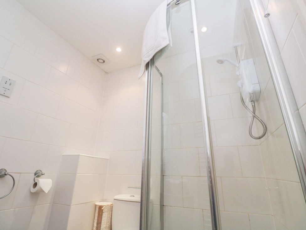 A bathroom with a shower and toilet at 87 Atlantic Reach Newquay
