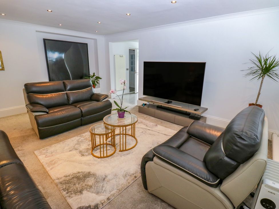 A living room with sofas and a television at Nabwood views