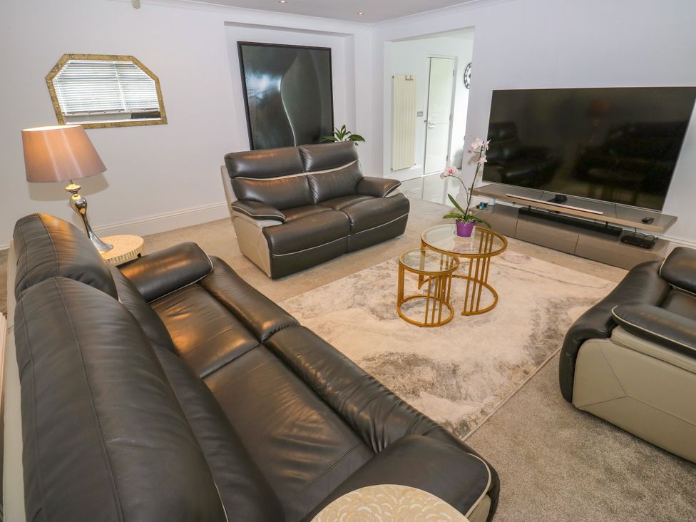 A living room with sofas and a television at Nabwood views