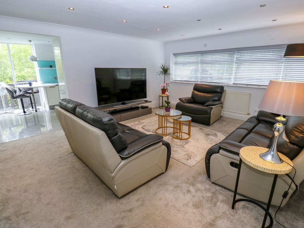 A living room with furniture and television at Nabwood views