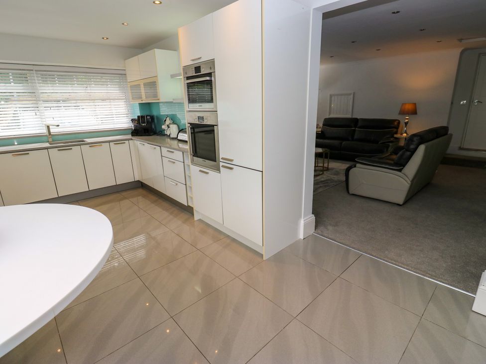 A kitchen with cabinets and appliances at Nabwood views
